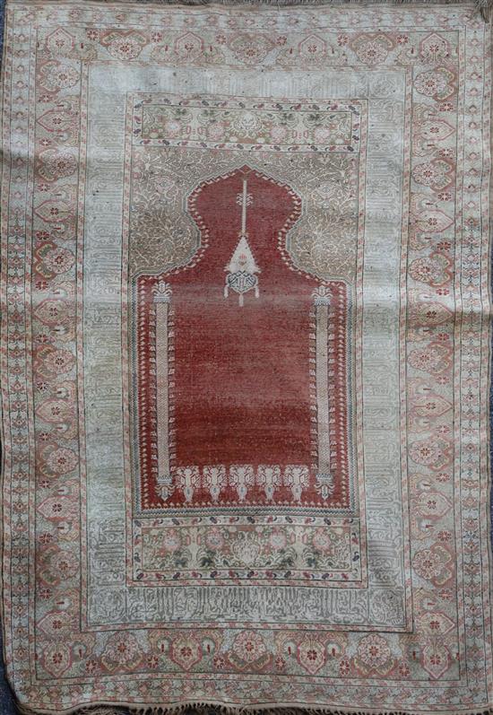 A Turkish Kum Kapri silk red ground hanging prayer rug, 6ft 6in by 4ft 6in.